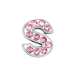 Close-up of pink crystal-encrusted S-letter charm with polished silver finish