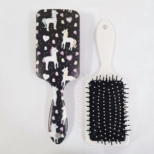 Detail of square cushion hairbrushes with unicorn patterns and soft massage bristles