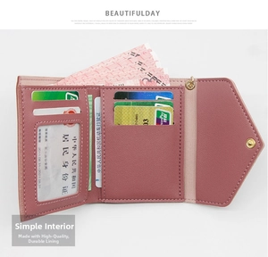 Detail of pink tri-fold wallet showing multiple card slots and clear ID window