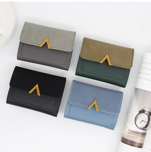 Detail of four colorful trifold wallets with golden V-shaped buckles and fine stitching