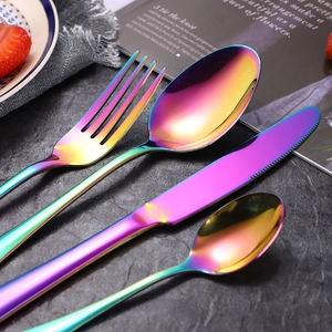 Rainbow stainless steel 4-piece cutlery set with knife fork and spoons on marble background