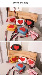 Detail showing colorful crossbody heart bags with striped straps and leather tassels
