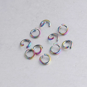 Close-up of iridescent rainbow stainless steel open jump rings for DIY jewelry making