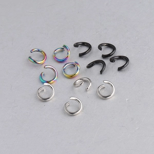 Detailed view of stainless steel jump rings in silver, black and rainbow finishes