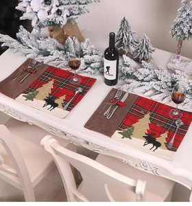 Christmas plaid placemat with reindeer embroidery in a festive dining table setting