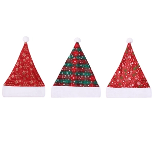 Three plush Christmas hats featuring red plaid and gold snowflake patterns on white background