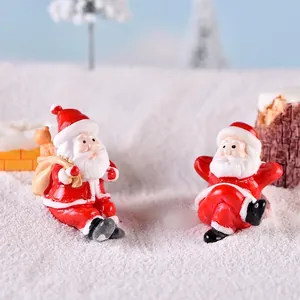 Miniature Christmas Santa Claus resin figurines in snow scene with gift bag ornaments