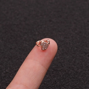 Close-up of a small rose gold heart hoop earring with micro-paved sparkling cubic zirconia