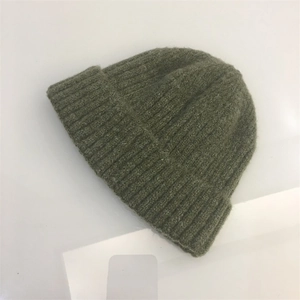 Detail of olive green mohair knit beanie featuring chunky ribbed texture and folded cuff