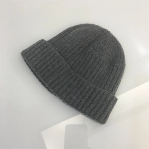 Detailed view of dark grey ribbed knit texture and folded cuff on beanie