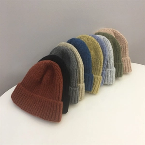 Stacked display of colorful knit beanies showing various shades and soft wool texture