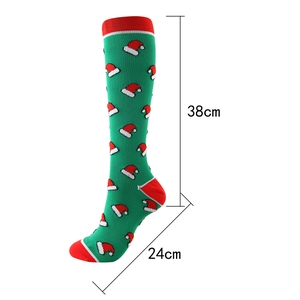 Christmas knee-high compression socks with green base, red holiday patterns and size specs