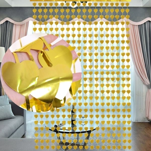 Detail view of heart-shaped gold sequin curtain showing metallic texture and reflective finish