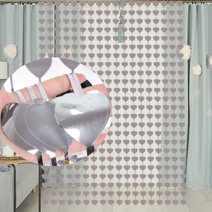 Detail of silver heart-shaped fringe curtain with reflective metallic sequin finish