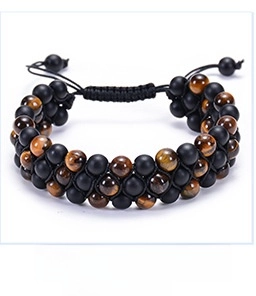 Close-up of triple-row beaded bracelet with tiger eye stones and matte black beads