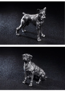 Detailed view of metal dog figurines showing textured fur and antique silver finish