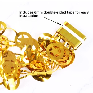 Detail of gold foil star and ring garland with adhesive tape for party decoration