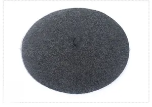 Detailed top view of a dark grey wool blend beret showing textured felt fabric finish