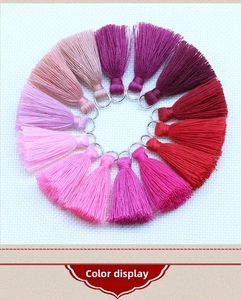 Macro view of 3.5cm cotton tassels with metal rings in various vibrant gradient colors
