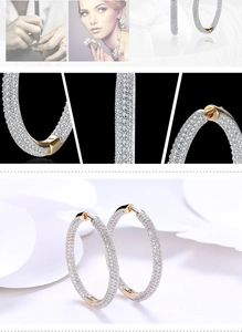Detail of large gold hoop earrings with white micro-pave cubic zirconia crystals