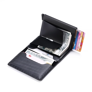 Detail of black carbon fiber RFID blocking wallet with pop-up card mechanism and money clip