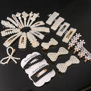 Elegant pearl and bow hair clip set featuring gold alloy frames on a sleek black background