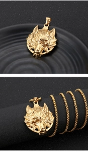 Detail of a golden wolf head pendant made of stainless steel with a matching box chain