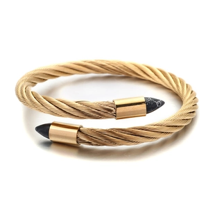 Gold twisted cable open cuff bracelet featuring black marble patterned arrow tips