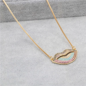 Macro shot of gold-plated lip pendant necklace with vibrant multi-colored zircon stones