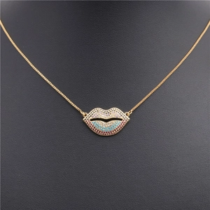 Detail of gold lips pendant necklace with colorful cubic zirconia on a black mannequin