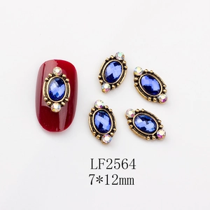 Macro view of blue gemstone nail art charm with 7x12mm vintage gold frame detailing