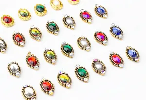 Macro shot of oval vintage alloy nail art rhinestones with colorful crystals and gold frames