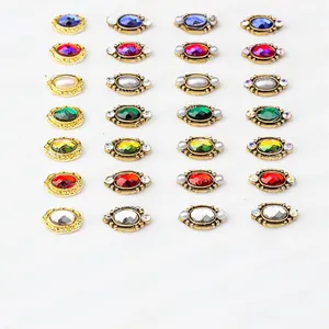 Detailed grid of vintage oval alloy nail art charms with pearls and colorful rhinestones
