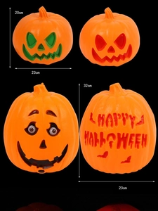 Detail of assorted glowing Halloween pumpkins in 20cm and 32cm sizes on black background