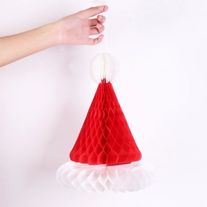 Detail of red and white honeycomb paper Christmas hat decoration with hanging string