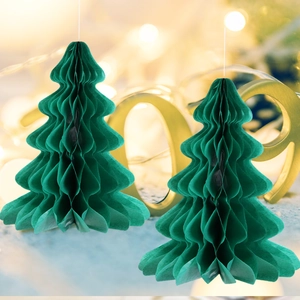 Close-up of green honeycomb paper Christmas tree ornaments with festive bokeh lighting