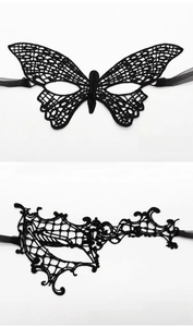 Detail of black lace butterfly and asymmetrical eye masks for masquerade parties