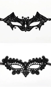 Detailed view of black lace party masks in bat and peacock styles for festive events