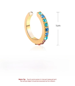 Close-up of golden U-shaped ear cuff with colorful rhinestones on white background