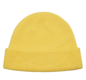 Close-up of yellow ribbed knit beanie showing textured wool fabric and folded brim detail