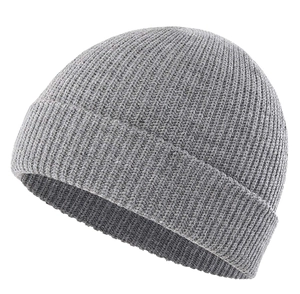 Macro detail of the grey ribbed knit texture and folded cuff on this winter beanie