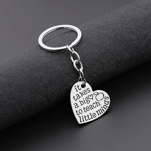 Macro view of silver heart keychain engraved with teacher appreciation message
