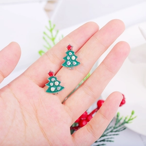 Detailed close-up of green enamel Christmas tree stud earrings with sparkling rhinestones