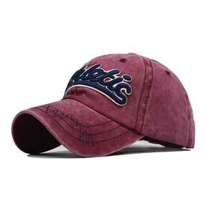 Close-up of vintage washed burgundy baseball cap with 3D Athletic embroidery and navy stitching