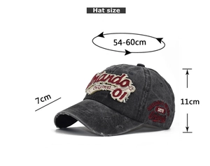 Detail of embroidered Orlando 01 letters on a washed dark gray denim baseball cap