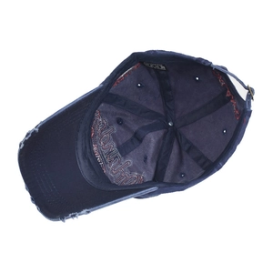 Detail of blue washed cotton baseball cap showing internal stitching and metal buckle