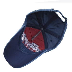 Detailed interior view of navy cotton baseball cap featuring red lining and quality stitching