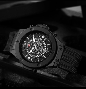 Detail of black sports watch dial featuring chronograph windows and date calendar display