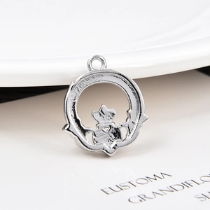 Macro detail of silver Claddagh heart charm pendant for DIY jewelry making
