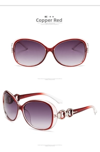 Detail of red and white fashion sunglasses with metal accents and gradient purple lenses